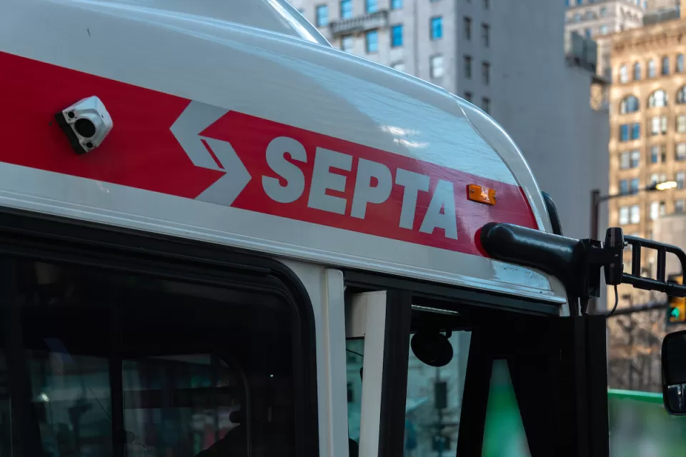 Close-up of SEPTA logo in white letters on red line at top of SEPTA bus in Philadelphia, Pennsylvania.